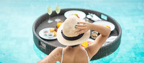 Preview: woman having floating breakfast in swimming pool