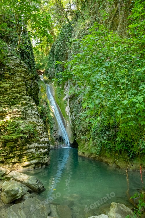 Preview: Stunning waterfalls and a blue lagoon lake.Beautiful landscape in summer.Majestic waterfall in the