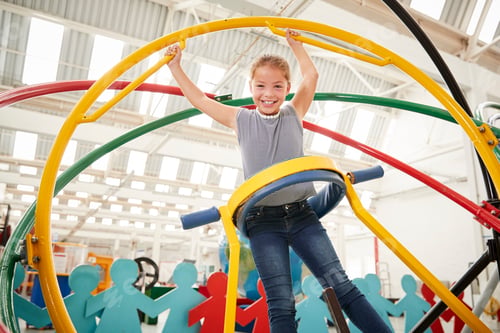 Preview: Young white girl having fun using a human gyroscope