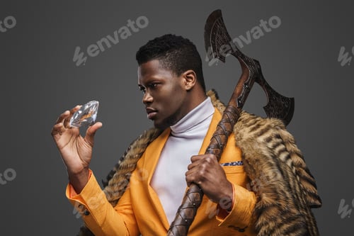Preview: Dark-skinned man holds massive diamond and axe against a neutral gray background