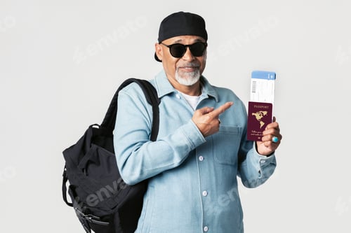 Preview: Happy black senior traveler with an air ticket and passport