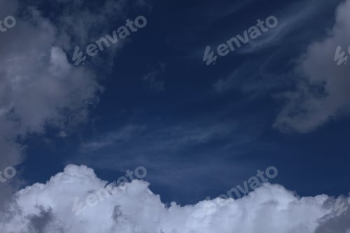 Preview: Dramatic White Clouds In Blue Sky - Photograph Of A Deep Blue Sky With A Variety Of Clouds Around