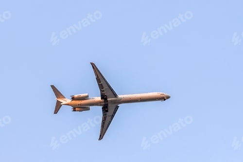 Preview: Flying commercial airplane against clear blue sky