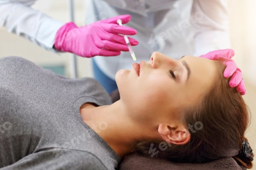 Preview: Attractive young woman gets cosmetic face injection