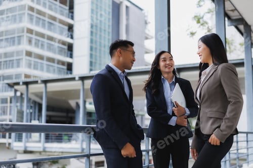 Preview: Business people talking and smiling outside office building