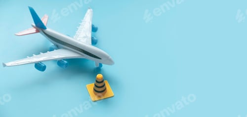 Preview: Fixing, maintenance and under construction concept. Traffic or safety cone with toy airplane.
