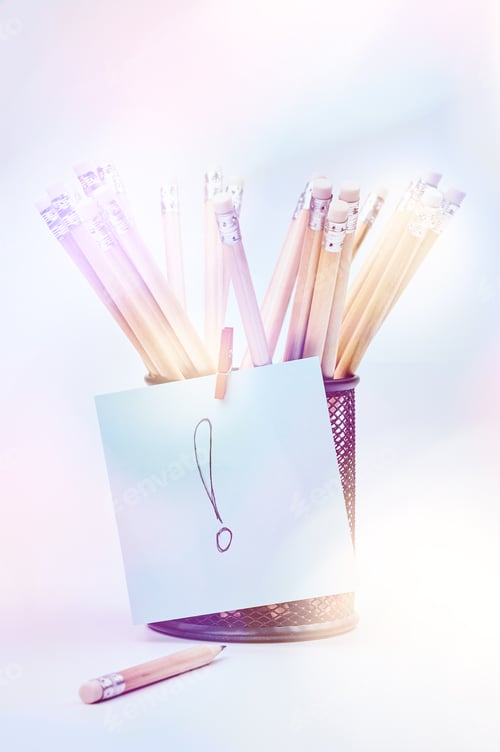 Preview: Group of pencils in a black basket with note paper, isolated on a white background.