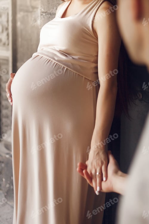 Preview: pregnant woman holding her belly bump