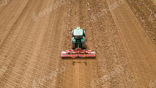 Preview: A farmer using a tractor to prepare the fields for planting. The image highlights the importance of
