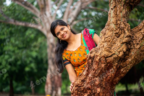 Preview: Young girl near tree trunk and she enjoying fresh air outdoors