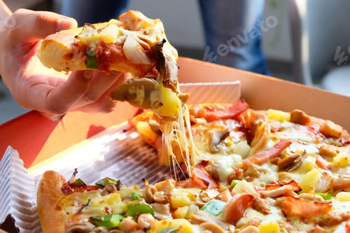 Preview: Man hand holding a pizza out of the box
