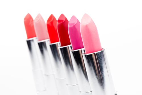 Preview: Close-up view of beautiful set of color lipsticks in a row isolated on white