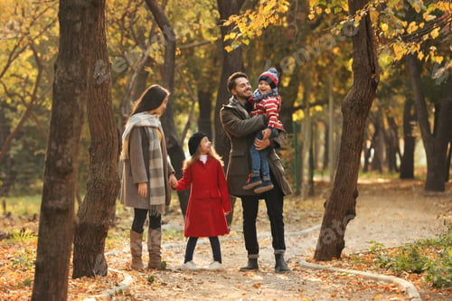 Preview: Happy family with children spending time together in park. Autumn walk