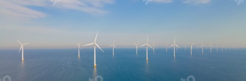 Preview: offshore windmill park with clouds and a blue sky