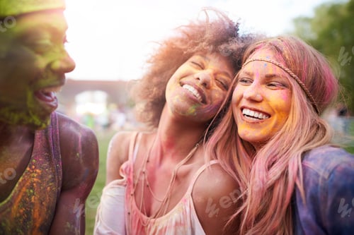 Preview: Group of friends at festival, covered in colourful powder paint