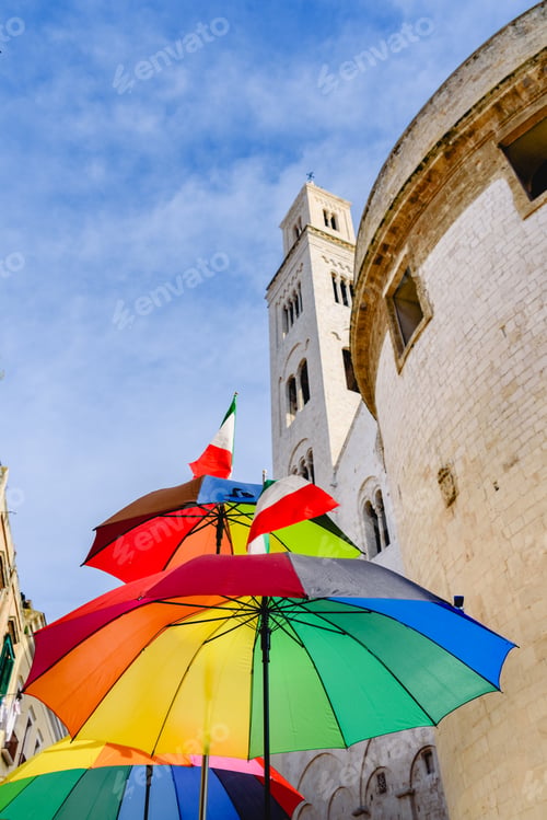 Preview: Funny colored umbrella with sky background in a city.