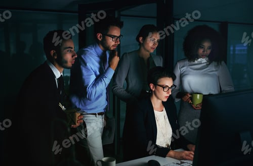 Preview: Cropped shot of a diverse group of businesspeople gathered around a single computer in their office