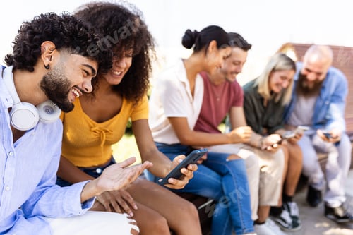 Preview: Happy young group of student friends watching social media content on phone app
