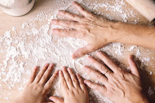 Preview: woman and child hands putting flour on the table