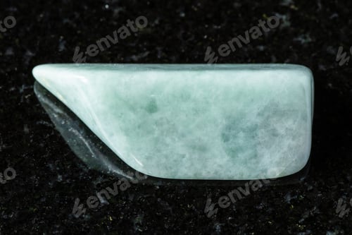Preview: sample of tumbled jadeite mineral on black granite