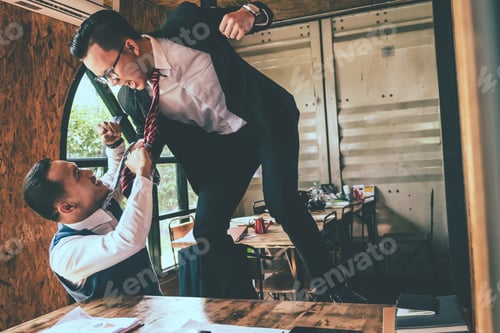 Preview: Businessman fighting with his coworker in office.