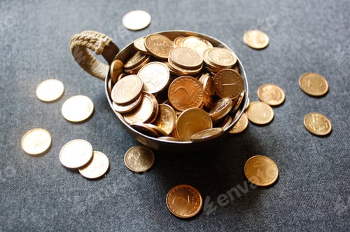 Preview: Golden coins in metal cup