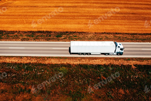 Preview: White truck on highway through countryside landscape, aerial shot