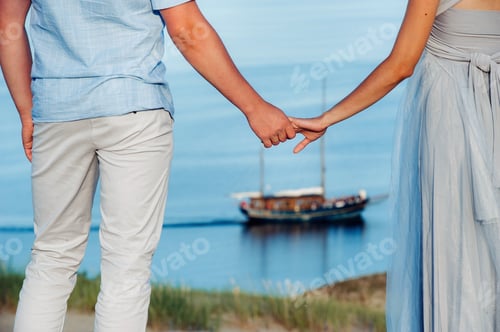 Preview: A couple in love stands on the beach in the dunes against the background of the Baltic sea and a