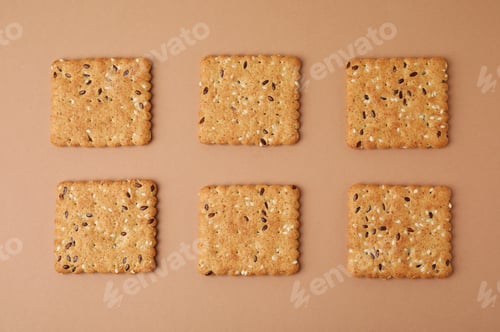 Preview: Cereal crackers with flax and sesame seeds on beige background, top view