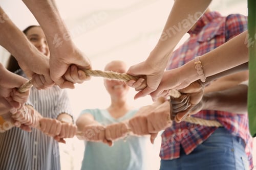 Preview: People holding rope together on light background, closeup of hands. Unity concept