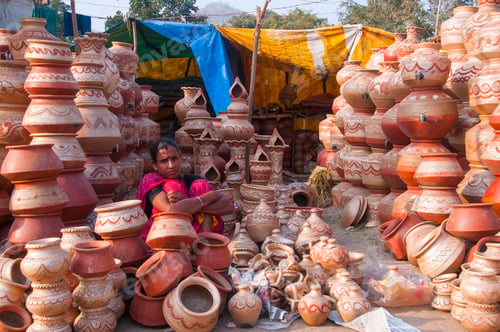 Preview: Woman selling earthen pots by the roadside at village of India.