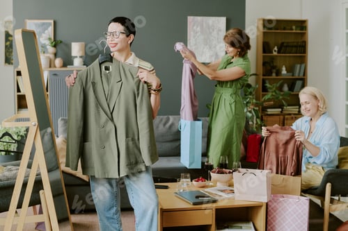 Preview: Caucasian Woman Smiling While Trying on Jacket at Home