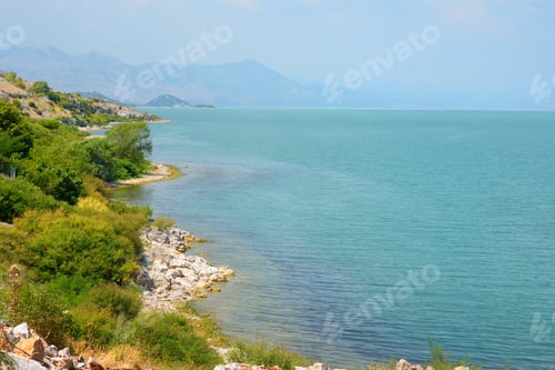 Preview: Stunning view of the shore of wonderful Skadar lake on the background of mountains