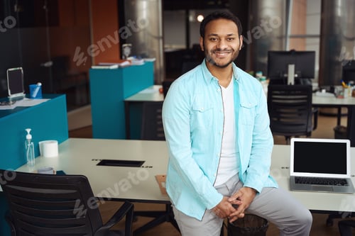 Preview: Portrait of happy male standing near desk on job