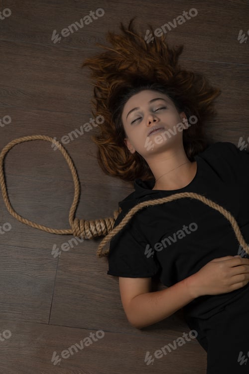 Preview: Young woman laying on the floor with Hangman's knot