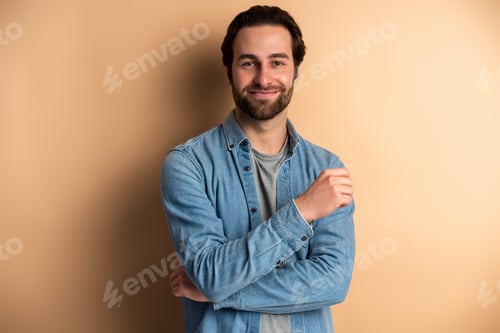 Preview: Image of a pleased caucasian guy posing isolated over orange wall background