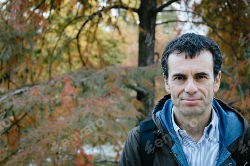 Preview: Confident man in a park with trees with space for copy