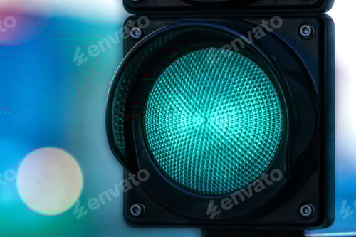Preview: close-up of traffic semaphore with green light on defocused city street background with copy space