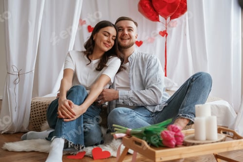 Preview: Festive decorations, Valentine's day. Young couple are together at home