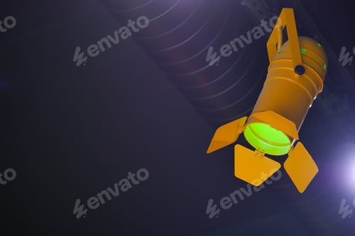 Green light shines from a yellow spotlight in a dark room