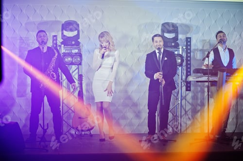 Preview: Musicial music live band performing on a stage with different lights.