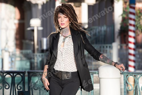 Preview: Pretty tattooed woman with dreadlocks
