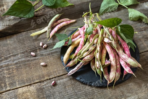 Preview: Beans of bean, brown bean (of dried beans) bunch harvest on a rustic table.