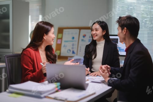 Preview: Asian business team collaborating on project in office meeting