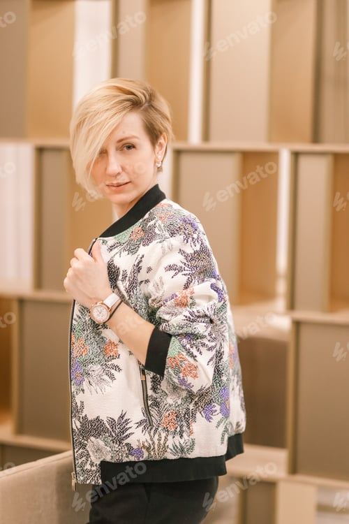 Preview: Stylish Woman Poses Indoors with Floral Jacket
