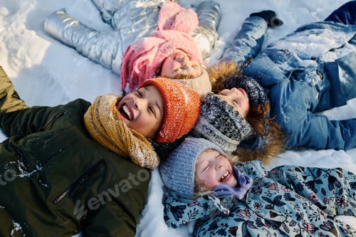 Preview: Children lying on snow and laughing