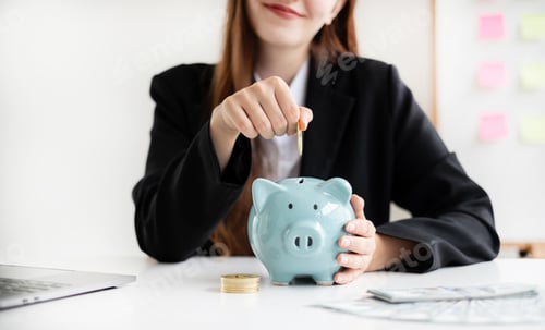 Preview: Asian woman putting coin into piggy bank. Saving money with coins Step into a business that