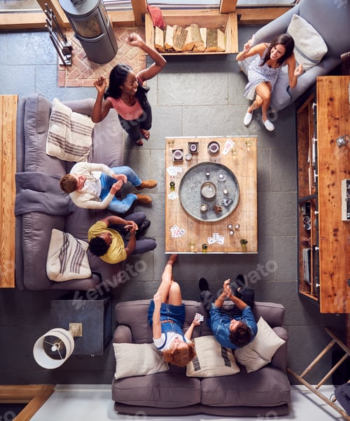 Preview: Overhead Shot Of Multi-Cultural Group Of Friends At Home Playing Cards And Drinking Beer And Wine