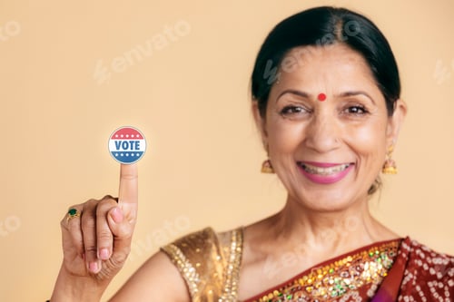 Preview: Indian woman showing a vote sticker