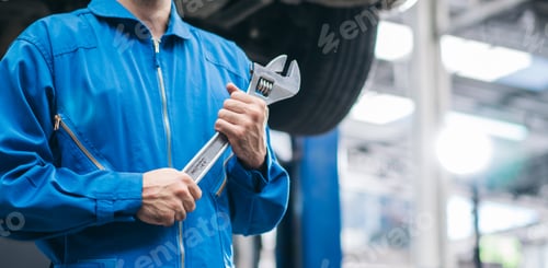 Preview: Mechanic hand holding wrench equipment tool in auto repair garage